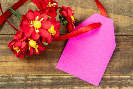 christmas decorative elements next to card with red ribbon and copy spaceの写真素材