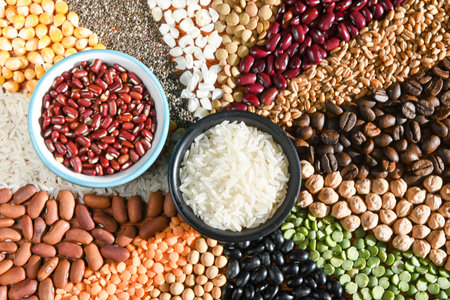 Bowl with raw white rices and beans on various seedsの写真素材
