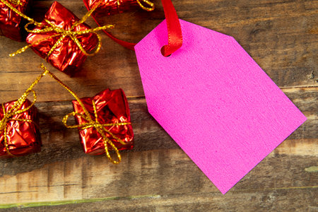 christmas decorative elements next to card with red ribbon and copy spaceの写真素材