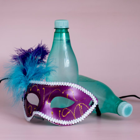 Hydration concept, drinking a lot of water during carnival holiday, bottle with venetian mascaraの写真素材