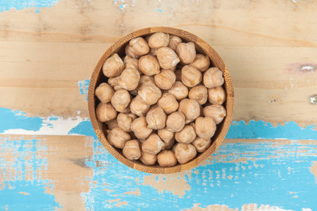 bowl with chickpea on blue rustic wooden table, top viewの写真素材