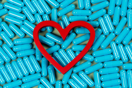 heart shape and blue capsules. Importance of treatment for problems