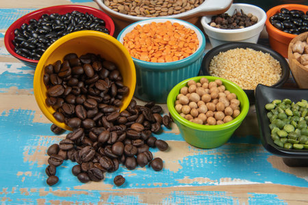 Coffee beans, lentils, beans, peas and cereals in bowlsの写真素材