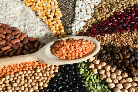 Different types of beans and lentils on wooden spoon, closeupの写真素材