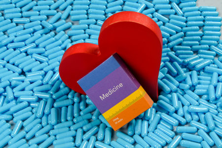 Conceptual image showing a heart and a box on a pile of blue pills