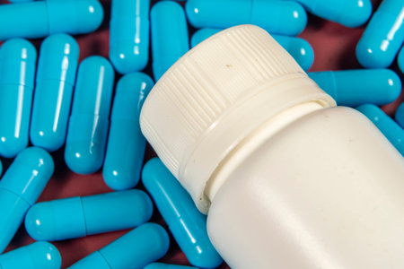 blue medicine capsules and white bottle symbolizing medicine