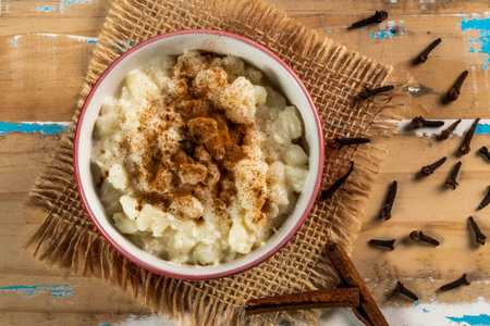 Typical Brazilian sweet dessert, made with Canjica corn. White porridge with cinnamon and coconut and condensed milk. Consumed in June festivities (junina party)の写真素材