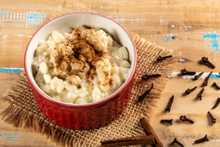 Typical Brazilian sweet dessert, made with Canjica corn. White porridge with cinnamon and coconut and condensed milk. Consumed in June festivities (junina party)の写真素材