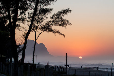 Recreio dos Bandeirantes beach at sunrise with the Pedra da Gavea mountain and the coastの写真素材