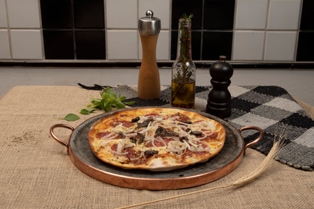 Brazilian pizza with pepperoni, cheese, onion and black olive , top viewの写真素材