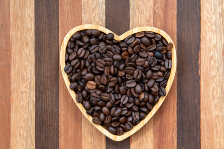 coffee beans in heart-shaped tray representing love of coffeeの写真素材