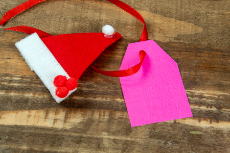Christmas decorative elements next to card with red ribbon and copy spaceの写真素材