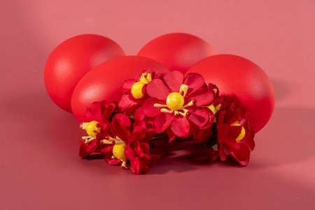 Colorful eggs symbolizing Easter on a colorful background and flowersの写真素材