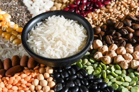 Bowl with raw white rice on various seedsの写真素材