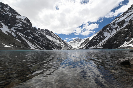 Laguna del Inca is a lake in the Cordillera region, Chile, near the border with Argentina. The lake is in the Portillo region: incredible landscape, blue sky, reflection of the water, in summerの写真素材
