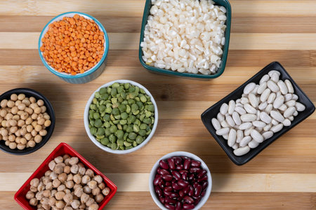 several bowls with raw grains for preparing culinary dishes, top view