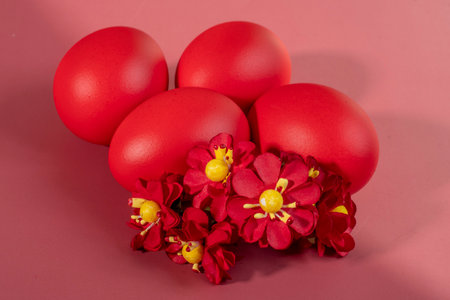 Colorful eggs symbolizing Easter on a colorful background and flowersの写真素材