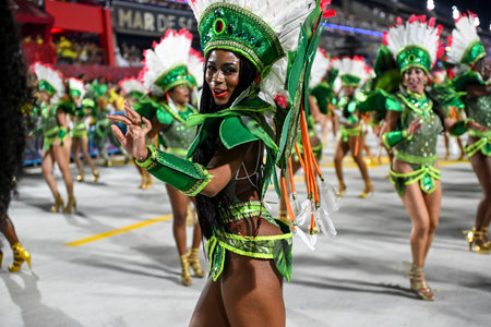 Rio de Janeiro, Brazil - February 13, 2026: A performer from Unidos de Bangu samba school parades at...