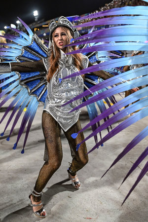 Rio de Janeiro, Brazil - February 14, 2026: A performer from Imperio Serrano samba school parades at...