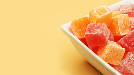 turkish delight in a white bowl on an orange background. close up.