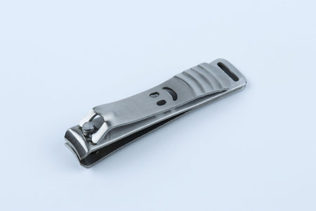 Smiley face metal nail clippers on white backgroundの写真素材
