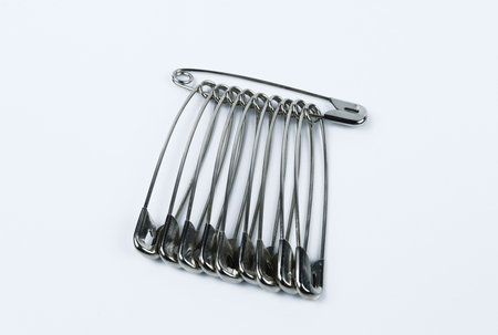 Metal safety pins isolated on white background