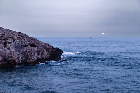 Beautiful seascape with sea and mountain in the evening.の写真素材
