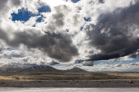 landscape with snowy mountains and blue sky with clouds