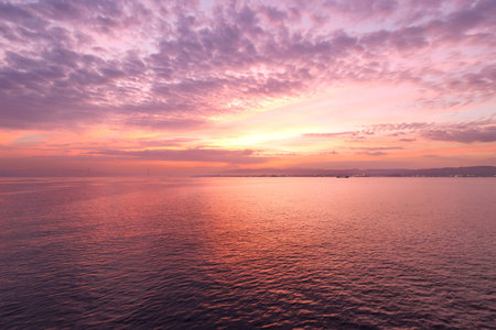 Beautiful sunrise at the sea. The sky is purple and pink.
