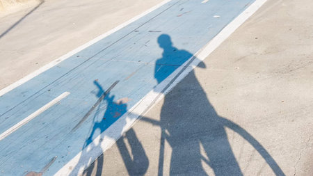 shadow of a man near a bike on the bicycle road