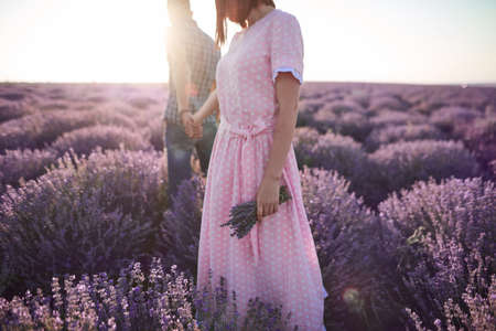 couple in love walk in the beautiful flower fieldsの写真素材