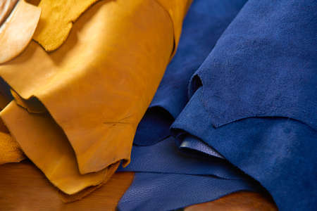 defocused rolls of natural brown and navy leather. Concept of materials for leather craftの写真素材