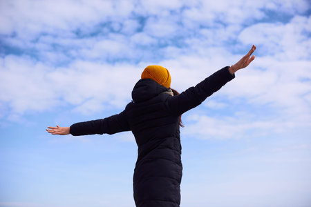 Freedom and feel good woman standing with open hands in airplane pose. Dreaming about flight