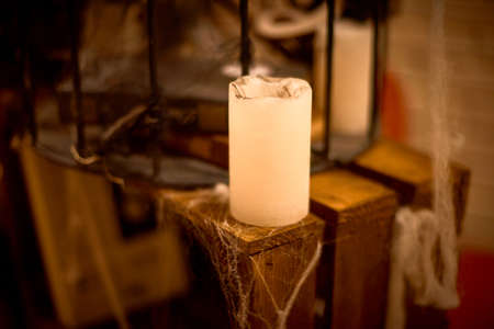 halloween evening decoration with cobwebs and burning candleの写真素材