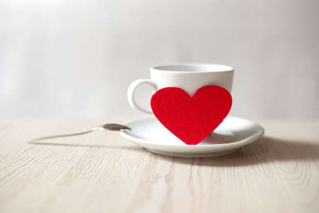 cup with red heart on table. saint valentine's day concept. shallow depth of field photoの写真素材