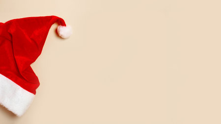 merry christmas and Happy New Year concept of card minimalism design. santa hat on beige background.の写真素材
