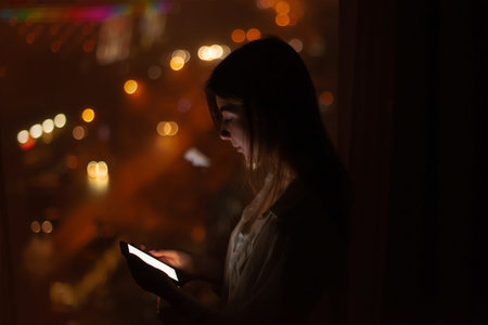 woman use smartphone at night. calls taxi through the application, orders home delivery of food....