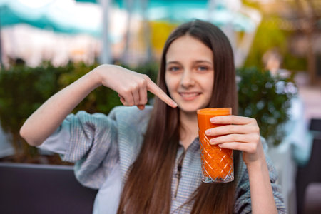 point on fresh juice of carrot or pumpkin. vegetarian break for student girlの写真素材