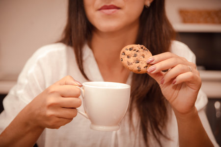 eating disorder due to problems and stress. woman eats up problems with sweet cookiesの写真素材