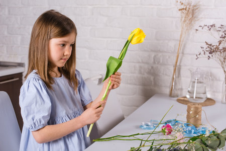 girl choose the best cut flowers for bouquet to make present for motherの写真素材