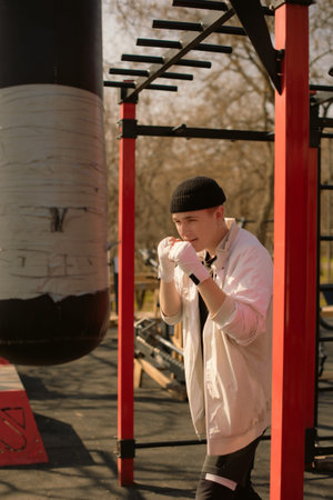 Young Fighter Training Solo with Punching Bag outdoors