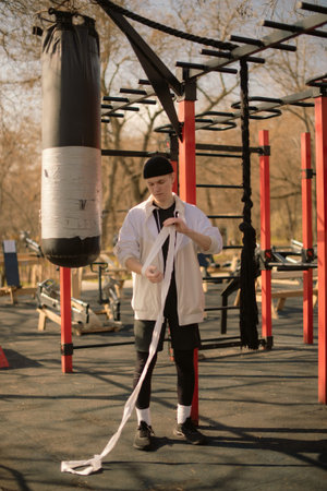 Pre-Fight boxing Routine: Boy Wrapping Hands Outdoors