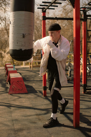 Boy Strengthens Skills with Outdoor Punching Bag Workout