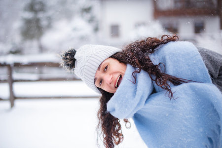 cold winter day woman enjoying snow in village near ski resort