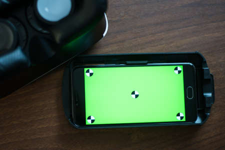 Virtual reality, VR, helmet and smartphone with green screen for key chroma screenの写真素材