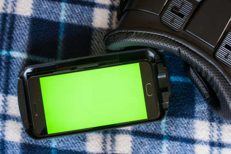 Virtual reality, VR, helmet and smartphone with green screen for key chroma screenの写真素材