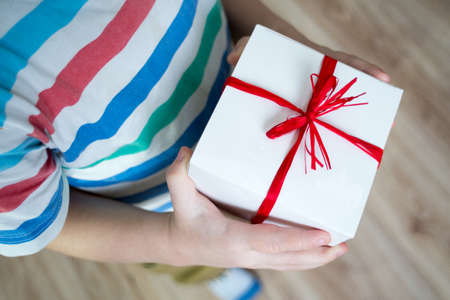 Box with a gift valentine heart in a child's hand on Valentine's Dayの写真素材