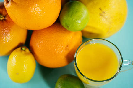 Fruit of citrus, orange, lime, lemon, pomelo, grapefruit with orange juice in a glass of glassの写真素材