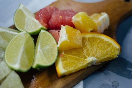 stack of citrus fruits slices. Oranges and lemons limes, grapefruit, pomelo. On wooden tableの写真素材