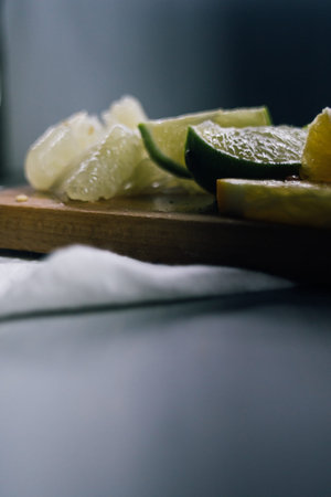 stack of citrus fruits slices. Oranges and lemons limes, grapefruit, pomelo. On wooden table